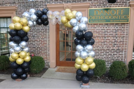Exterior of front of Danoff Orthodontics with balloon arch over door